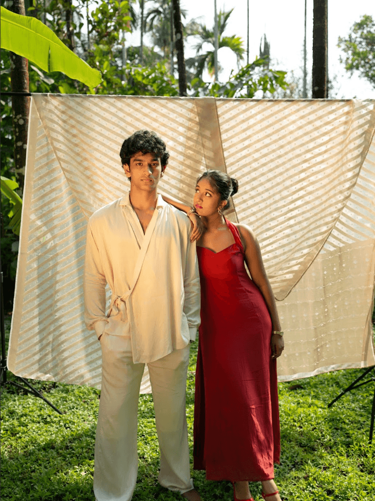 Image may contain Mithun Murali Clothing Dress Formal Wear Fashion Gown Evening Dress Adult Person Coat and Suit