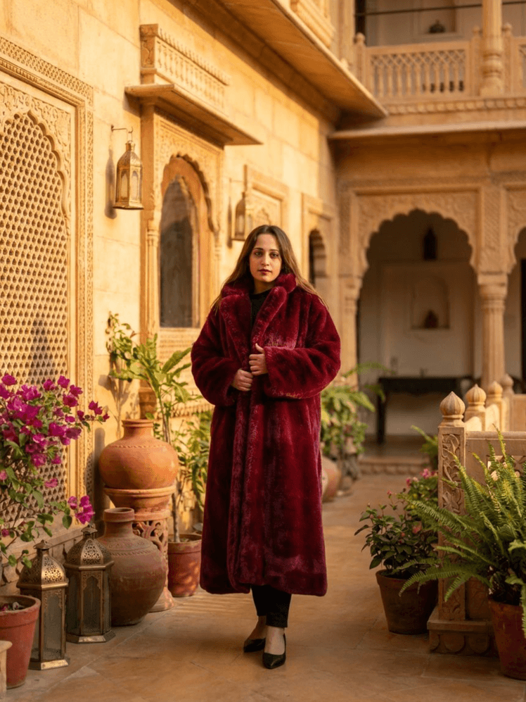 Image may contain Shweta Pandit Clothing Coat Plant Potted Plant Adult Person Jar Standing Pottery and Cookware