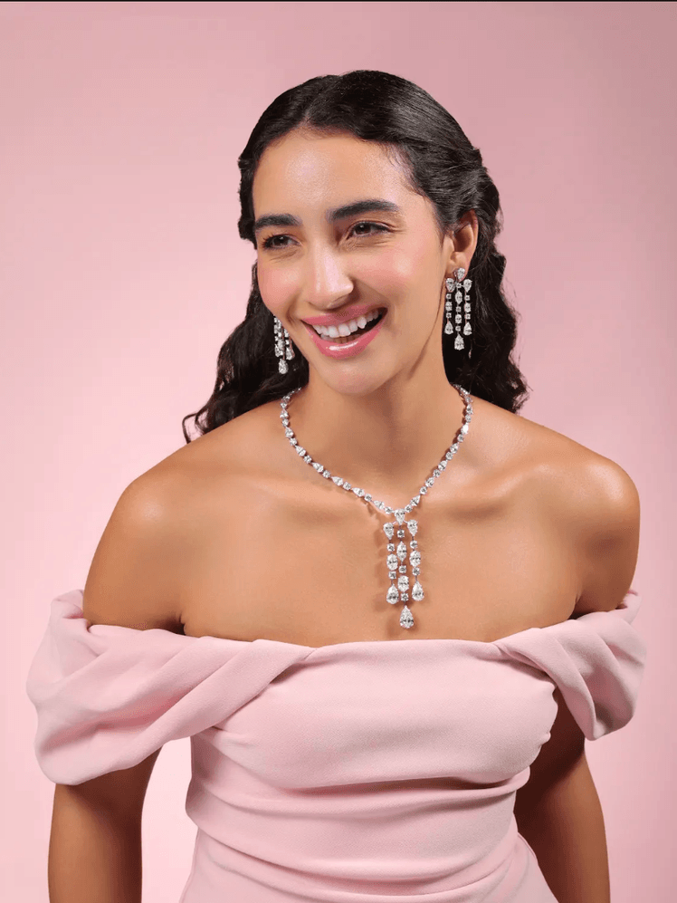 Image may contain Face Happy Head Person Smile Accessories Formal Wear Jewelry Necklace Clothing and Dress